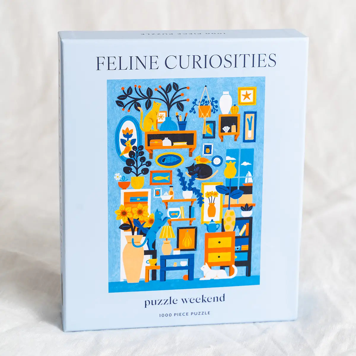Puzzle box titled 'Feline Curiosities' with a cat-themed illustration on a light background